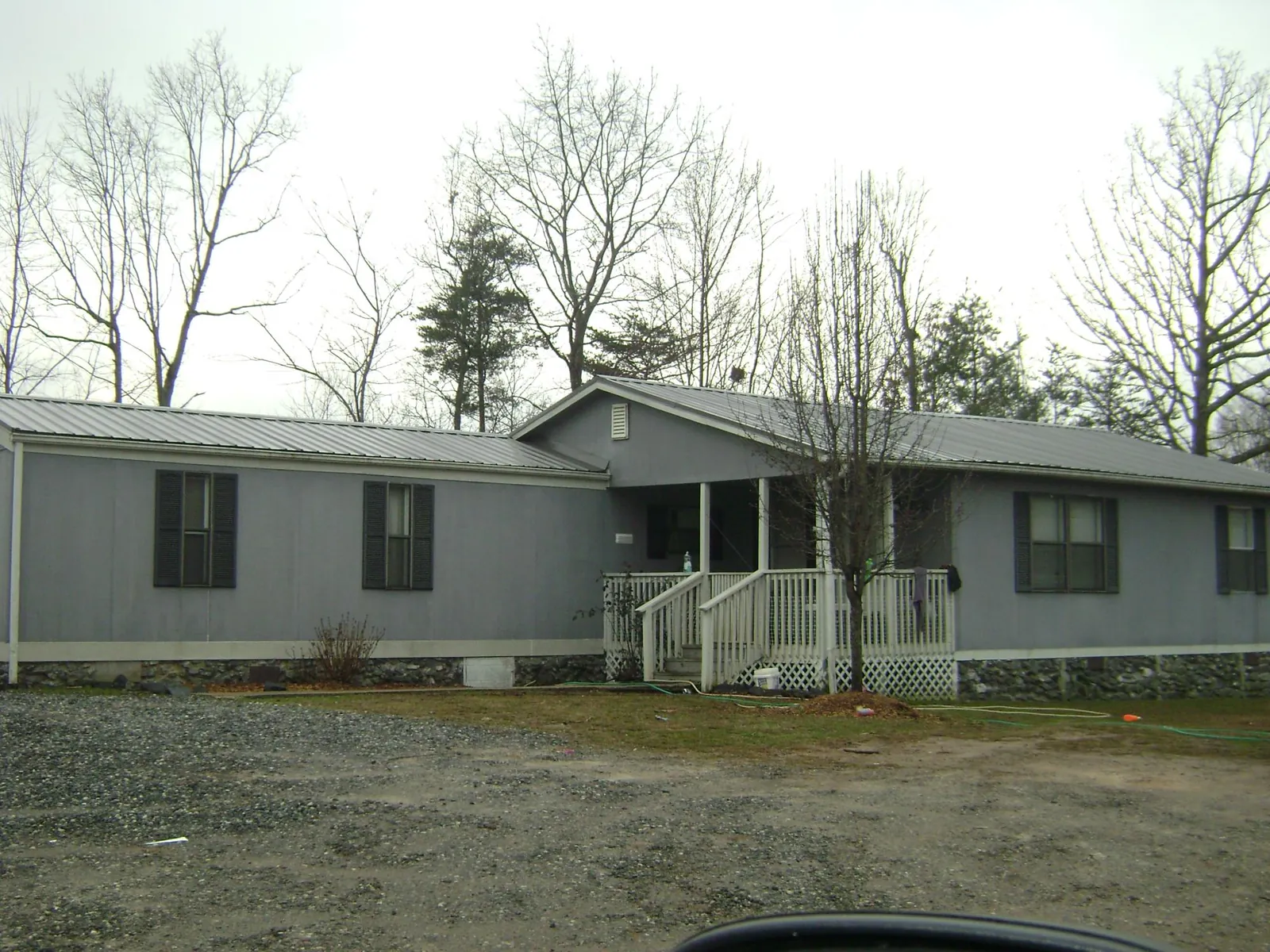 Metal roof over a manufactured home with a covered front porch in Washington